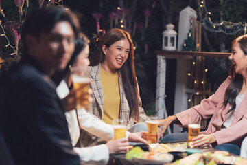 Nighttime Gathering:  A group of friends enjoy a casual night out, sharing laughter and drinks on a patio, creating a warm and inviting atmosphere.