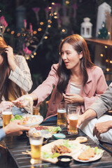 Night Out with Friends: A group of friends enjoy a casual dinner and drinks at a cozy restaurant, laughing and sharing stories.