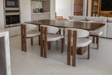 A modern wooden dining table with clean lines and a sleek finish. Its stylish design and durable construction make it the perfect centerpiece for a contemporary dining room.