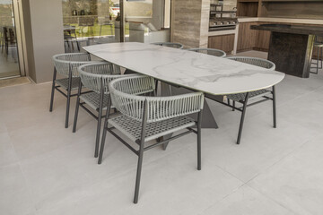 
A chic living room featuring a ceramic coffee table at the center, complemented by sleek, modern-designed chairs. The clean lines and minimalist style create a sophisticated and inviting atmosphere.