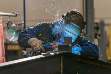 Welder, craftsman, assembly of iron, steel and other metals. Industrial steel welding technician in factory, construction professionals.
