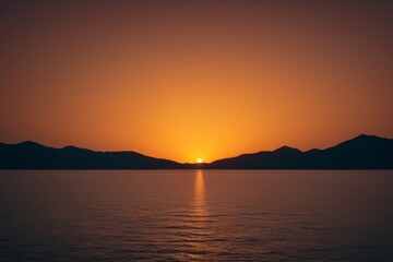 Fototapeta premium arafed view of a sunset over the ocean with mountains in the distance