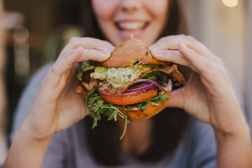 Woman Smiling Eating Burger