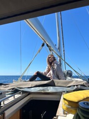 Enjoying a sunny day sailing on the ocean with a friend on a beautiful yacht