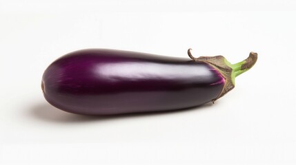 long curved purple eggplant on bright studio background featuring glossy texture calm still life copyspace concept of grocery cooking diet business
