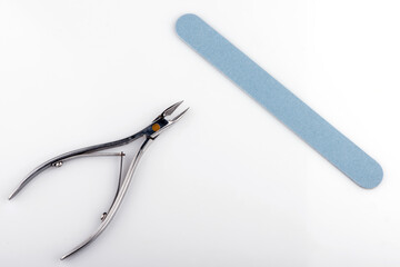 manicure accessories on a white background. manicure file. cuticle nippers