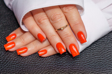women's hands with red manicure