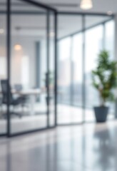 Modern office interior with glass walls and potted plant. Blurred corporate workspace background. Clean, bright business environment with copy space for text