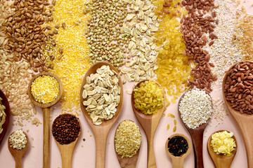 Colorful mix of grain varieties: oat and wheat, rice and millet, buckwheat and barley, quinoa and polenta. Food ingridients for healthy diet background, selective focus