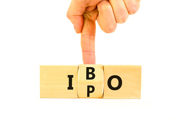 Initial public or bond offering symbol. Concept words abbreviation IPO or IBO on wooden block....