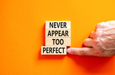 Never appear too perfect symbol. Concept words Never appear too perfect on beautiful wooden blocks. Beautiful orange table orange background. Business and never appear too perfect concept. Copy space.