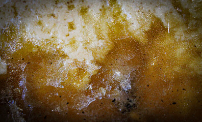 macro close-up of solid cooking fat with congealed lumps of greases and other liquids with...
