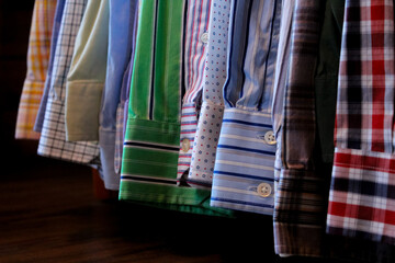 macro close-up of mens long sleeve dress business work attire shirts sleeves buttons lined up in a...