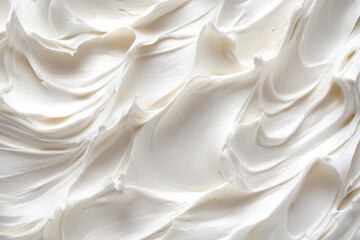 Obraz premium Close-up of the creamy texture of white whipped cream or meringue for a background, with ample copy space
