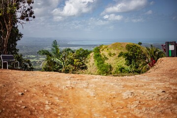 Bench overlooking lush valley and ocean in montana redonda, dominican republic