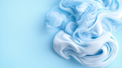 Fototapeta premium A blue and white swirl of smoke on a blue background