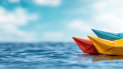 Fototapeta premium Three colorful paper boats floating in the ocean