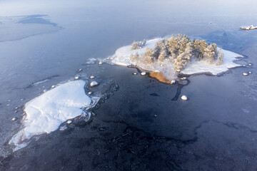 A snow-covered island in a sea covered with ice.