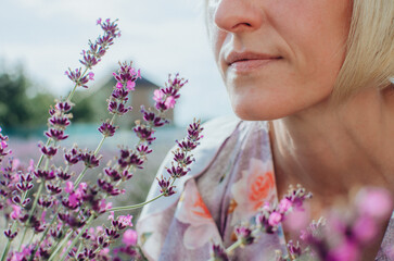 close-up of lavender flowers with a woman in the background