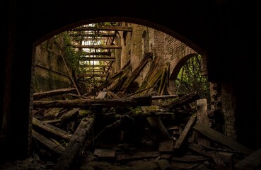 Crumbling arches and decaying beams inside abandoned building