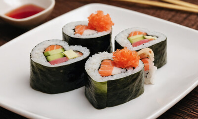 Colorful heart-shaped sushi rolls served on a plate with vibrant toppings and a small dish of soy sauce. Valentine’s Day idea, date, engagement party, love party, eat, food