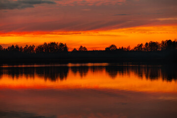 Fototapeta premium Experience the stunning sunset reflection that graces a serene and beautiful lake scene