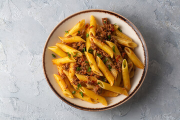 Penne pasta with minced meat and tomato sauce