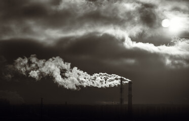 A man rising from a chimney against a background of clouds.Pollution of the Earth's...