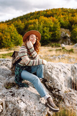 A woman is walking down a path in a rocky area. The path is narrow and rocky. Travel, adventure. Concept of an active lifestyle.