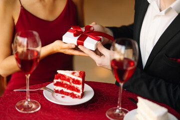 Romantic date on st. valentines day in the restaurant. Exchange of gifts.