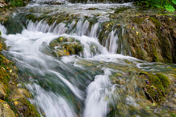 Low shutter speed shot of beautiful waterfall from hiking trail in Plitvice lakes national park