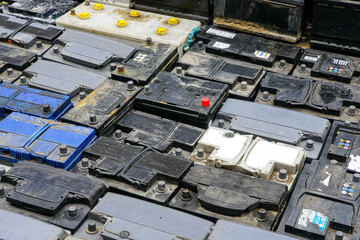 Stack of many used car batteries for recycling in a hazardous waste facility