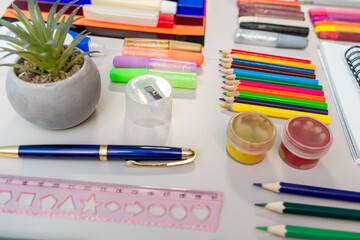 A diverse range of essential school supplies is neatly laid out on a table for use