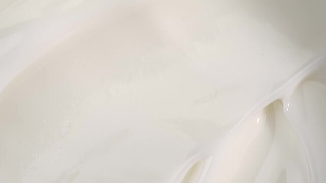 A woman takes a white face cream from a glass jar with her finger, macro. The concept of skin care for the body and face.