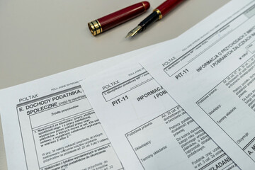 Obraz premium PIT-11 polish tax form on accountant table with pen close up. Tax time