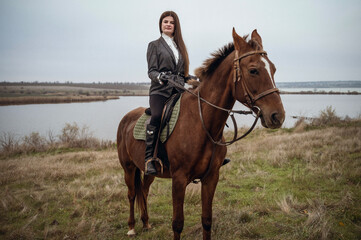 Fototapeta premium A person riding a horse in a field