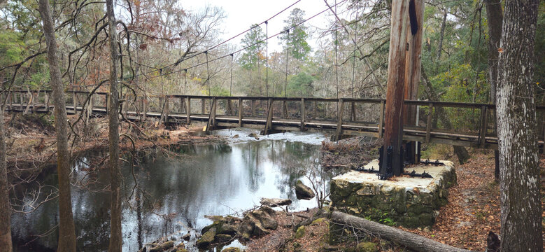 A tension bridge for pedestrians going over a river 