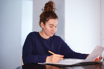 girl writing a letter at the table