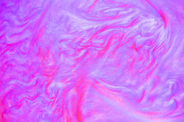 Shimmering multicolor abstract background. Liquid glitter paint texture waves and swirls. Beautiful shiny blue and pink glitter texture. Metallic paint close-up as a holiday background.