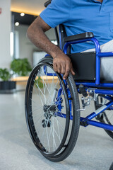 Obraz premium Close up of a man in blue tshirt sitting in a wheeling-chair