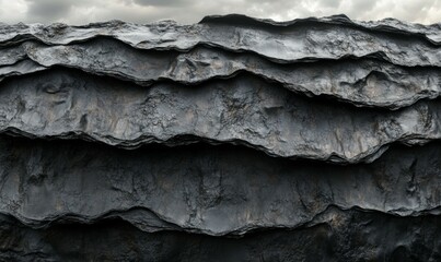 Blackened carbon landscape with textured layers and cloudy sky