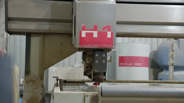 Automated saw is cutting the stone into the small slabs in a production workshop. Modern Industrial Processing CNC Saw Machine Spraying Water For Cooling. Manufacturing kitchen countertop quartz