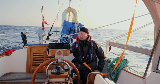 08.01.24 Sailor at the helm checking the autopilot while crossing the Bay of Biscay 