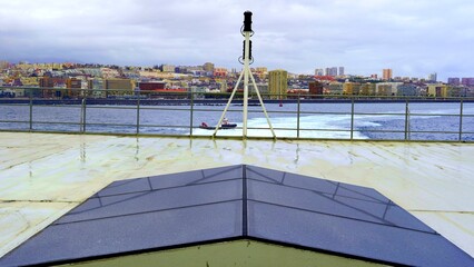 Fototapeta premium Ferry stern deck with cityscape and tugboat approaching in canary islands