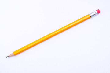 A yellow pencil isolated on a white background