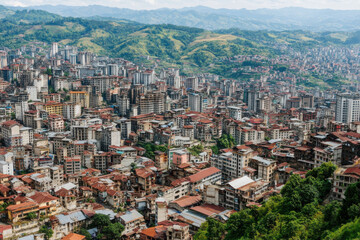 Fototapeta premium A city with a lot of buildings and a mountain in the background