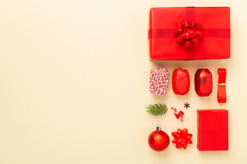 Handmade wrapped christmas gift boxes with stuff on color background, top view
