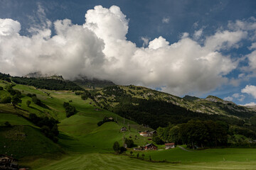 Hiking and traveling. Mountains landscape. Switzerland landscape. Swiss mountains and lake. Idyllic mountain scenery in the Alps with fresh green meadows.