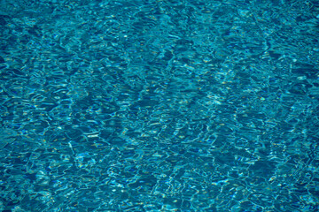 Pool water surface. Water texture. Swimming pool surface. Blue water background. Background of swimming pool water surface.