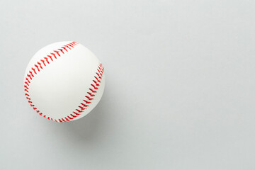 Baseball ball on color background, top view